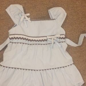 Soft blue little girls shirt with brown pants.